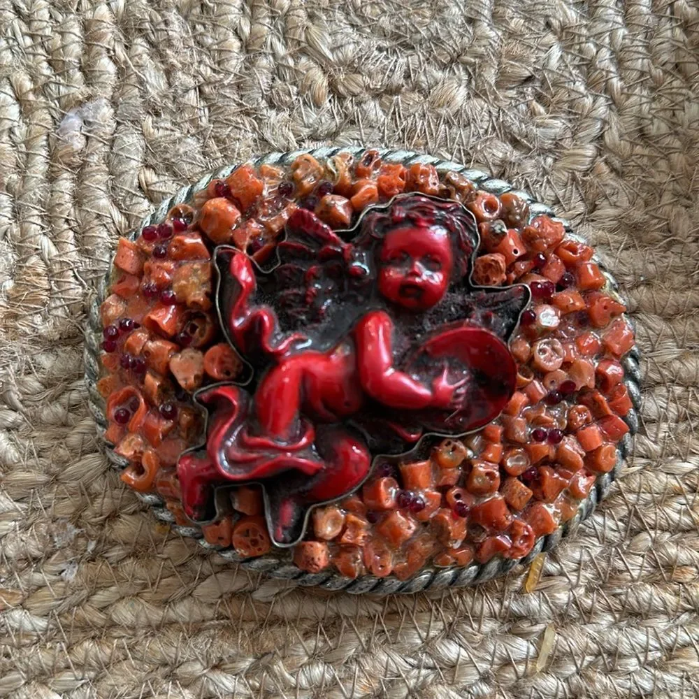 Handmade Coral Cherub belt buckle. One-of-a-kind.